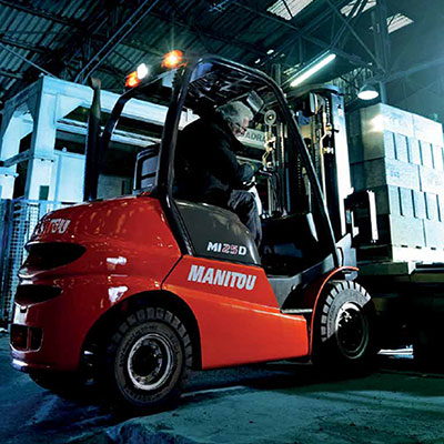 Picture showing a Manitou Lift Truck preparing to lift a load.